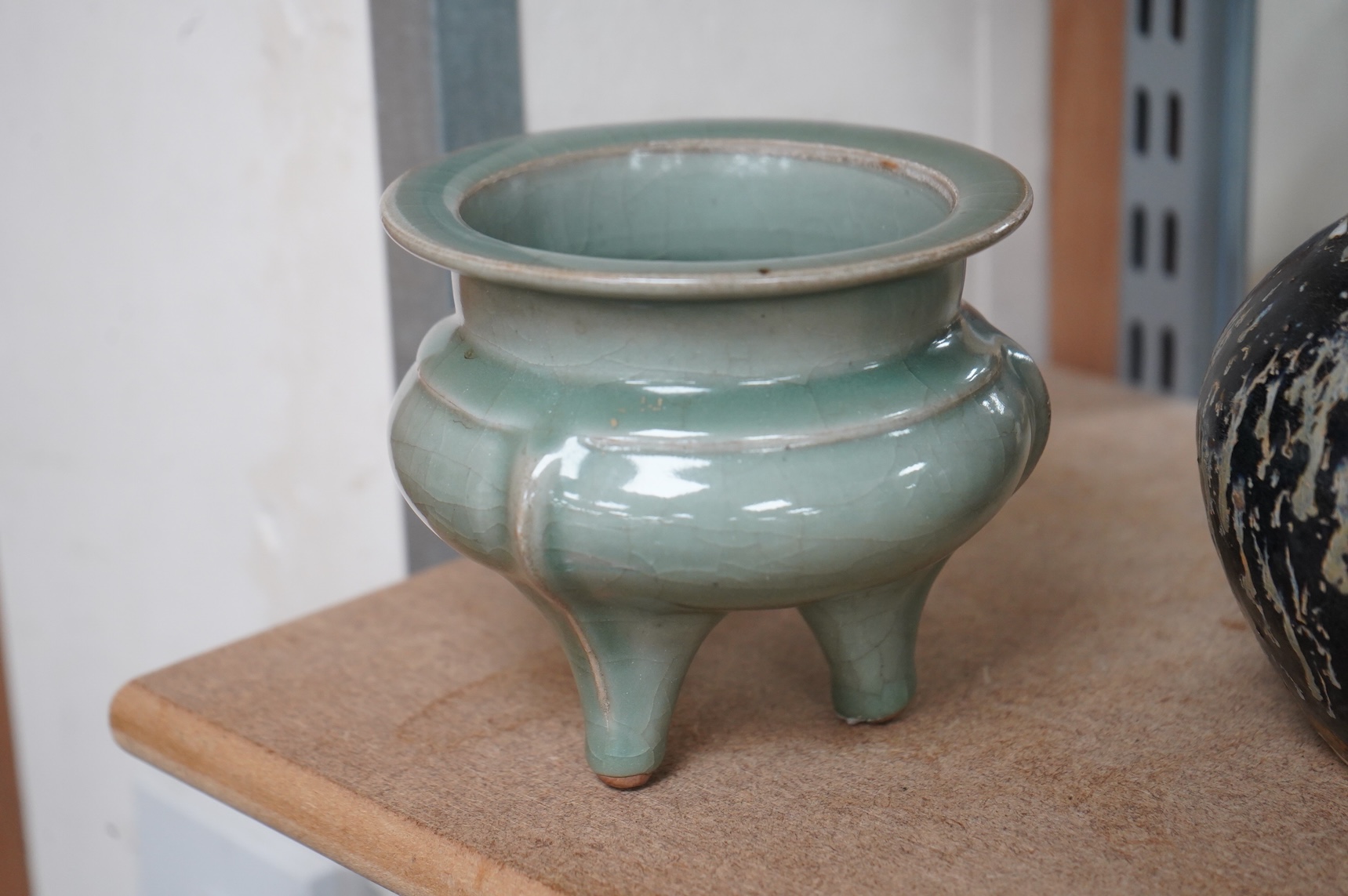 A Chinese celadon tripod censer and vase, largest 14cm high